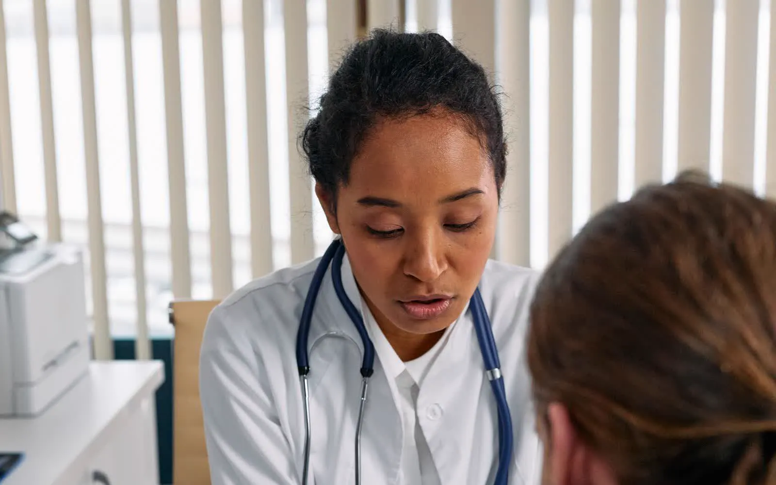 A doctor going over results with a patient in a clinic
